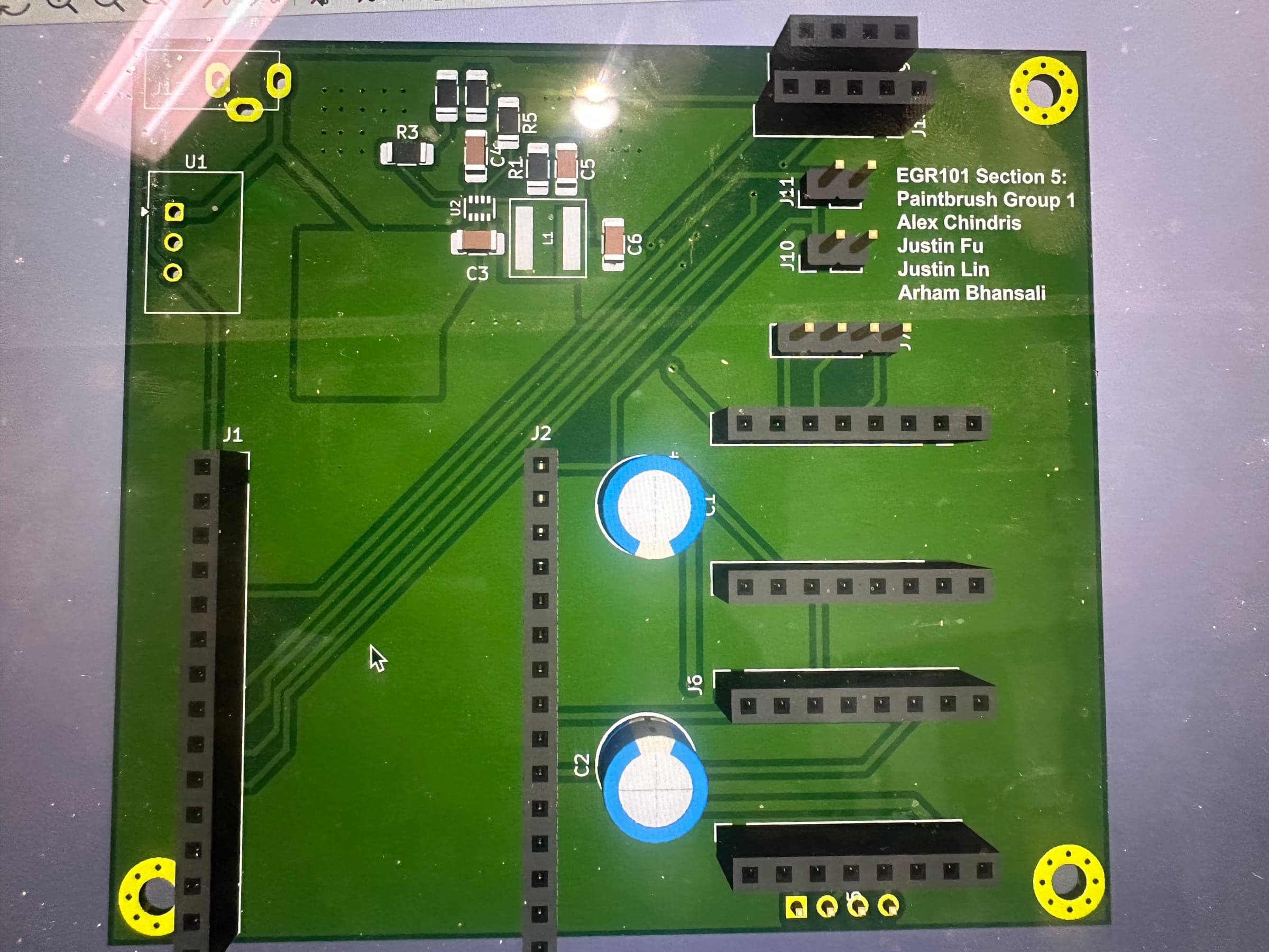 3D render of the control PCB showing headers for the ESP32 and stepper drivers and the team's names on the silkscreen